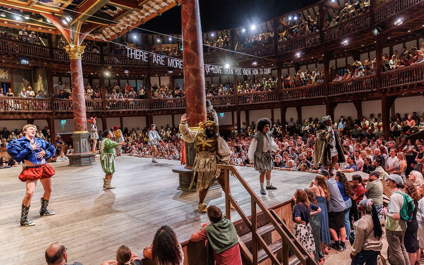 A group of actors onstage in front of an audience