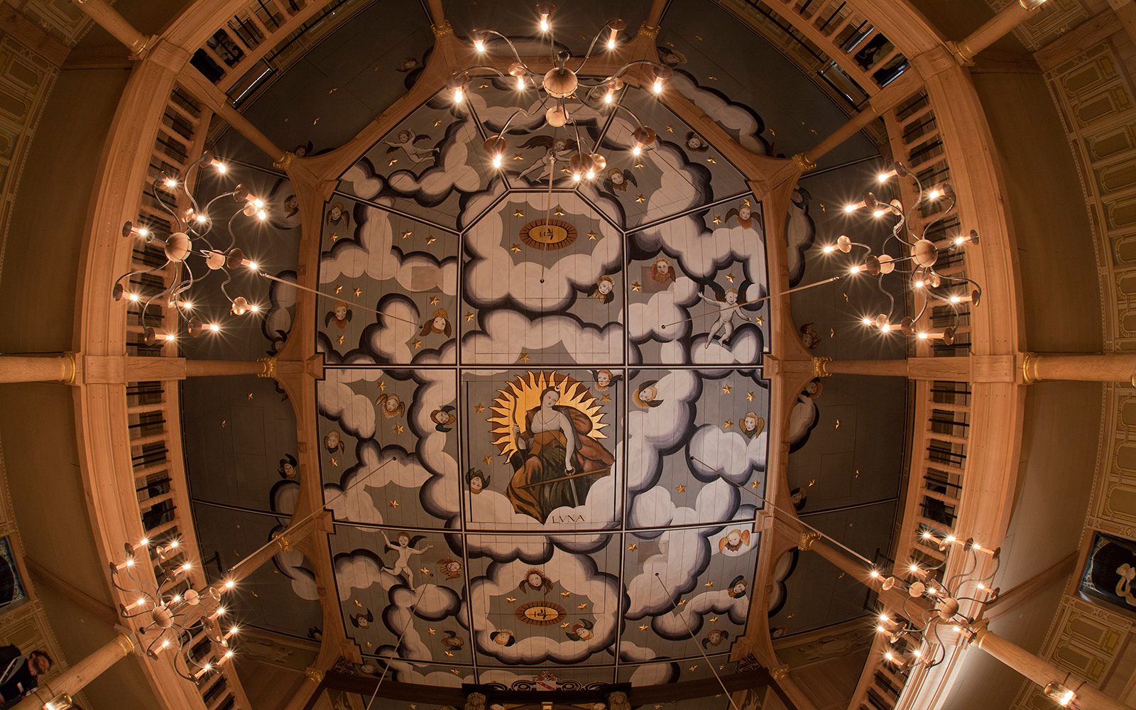 An intricately painted ceiling, looking up at it from below