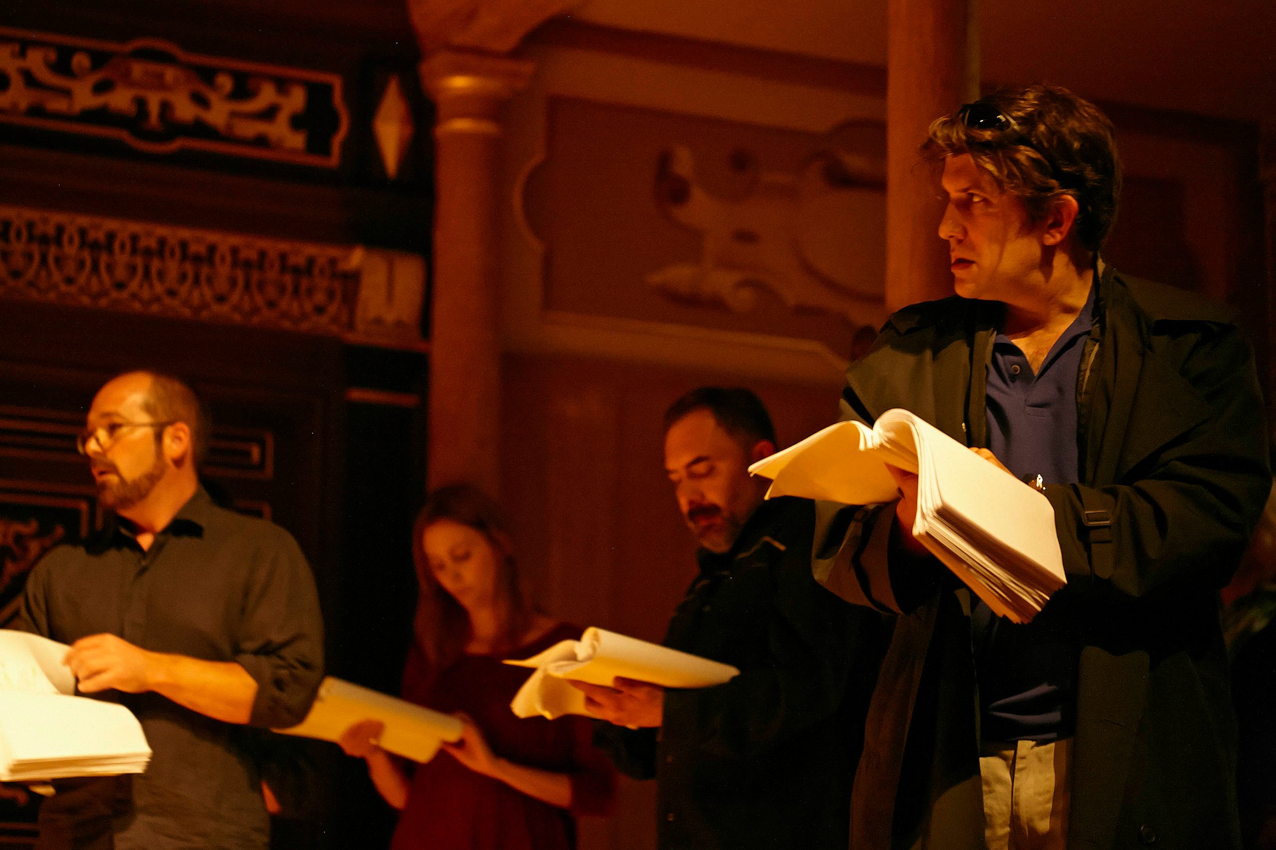 A group of actors read from scripts