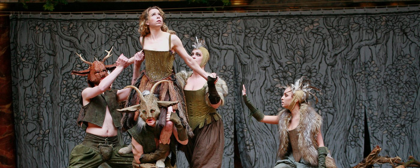 An actress is lifted by four other actors in woodland fairy costumes