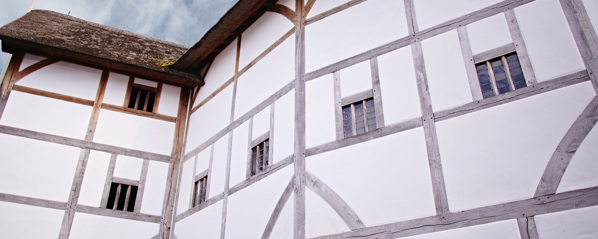 A close up of a white timber framed building