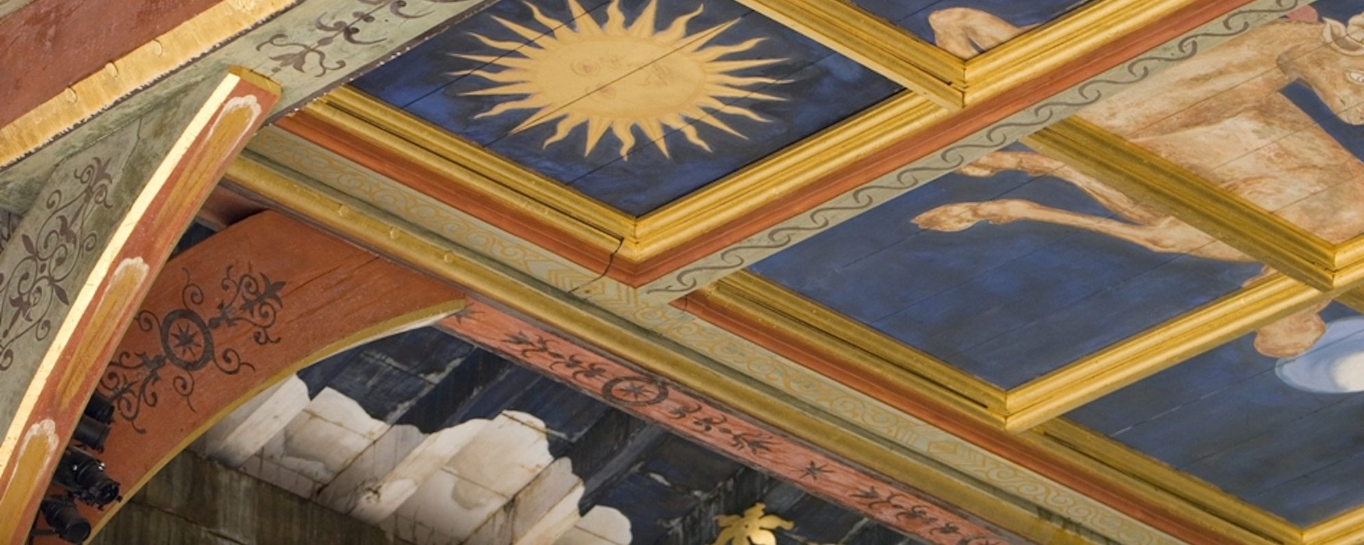 A painted ceiling which is blue and gold