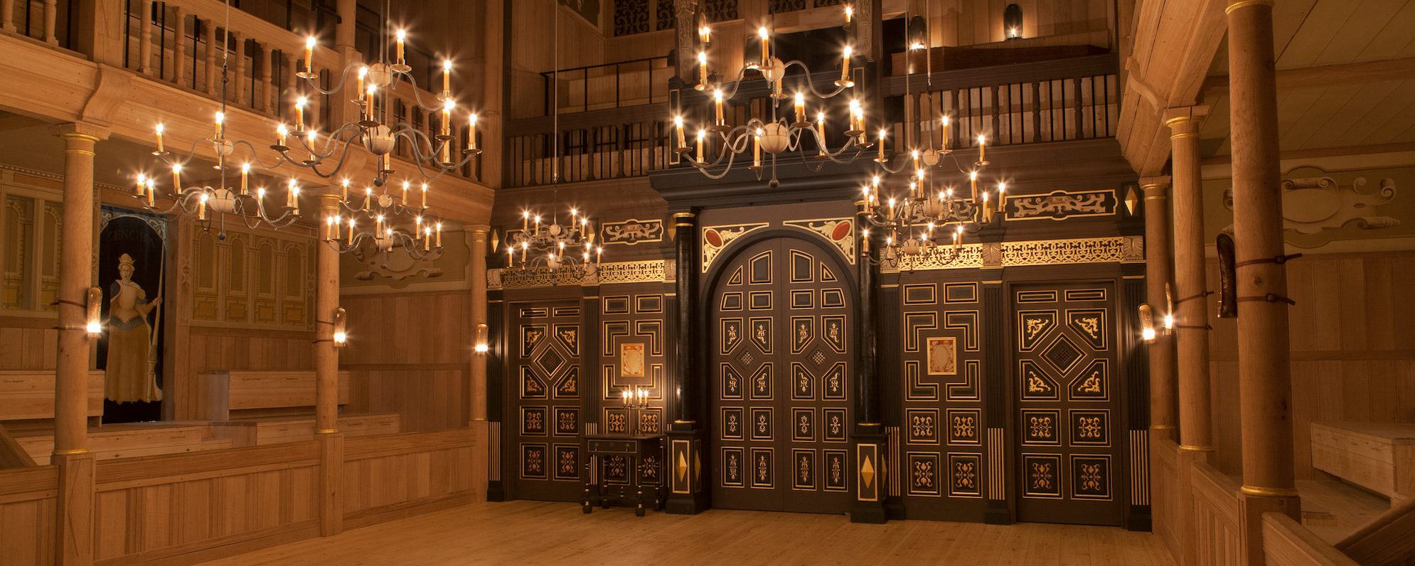 An indoor wooden playhouse lit by candles