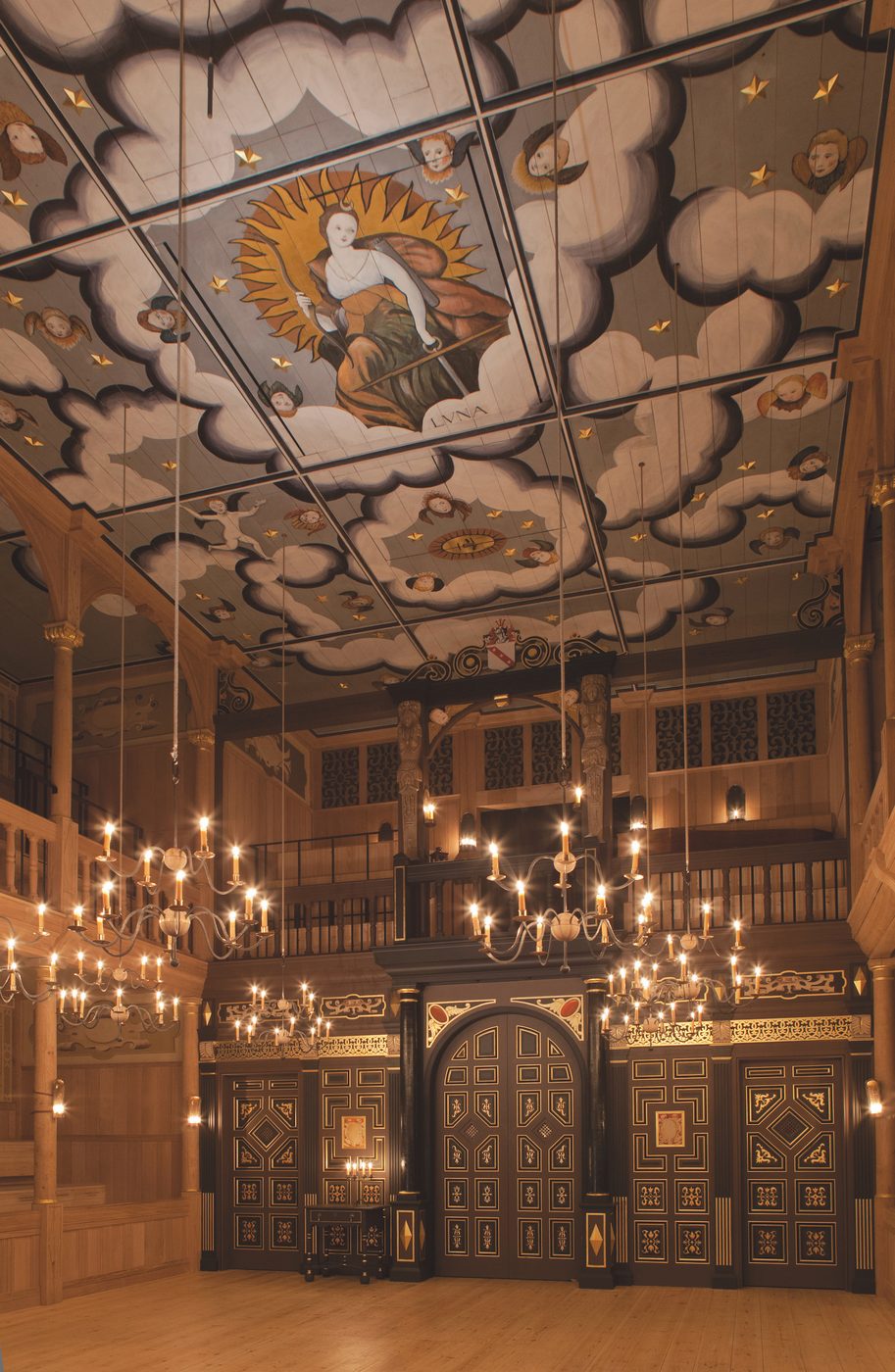 A tall ceilinged theatre with candelabras