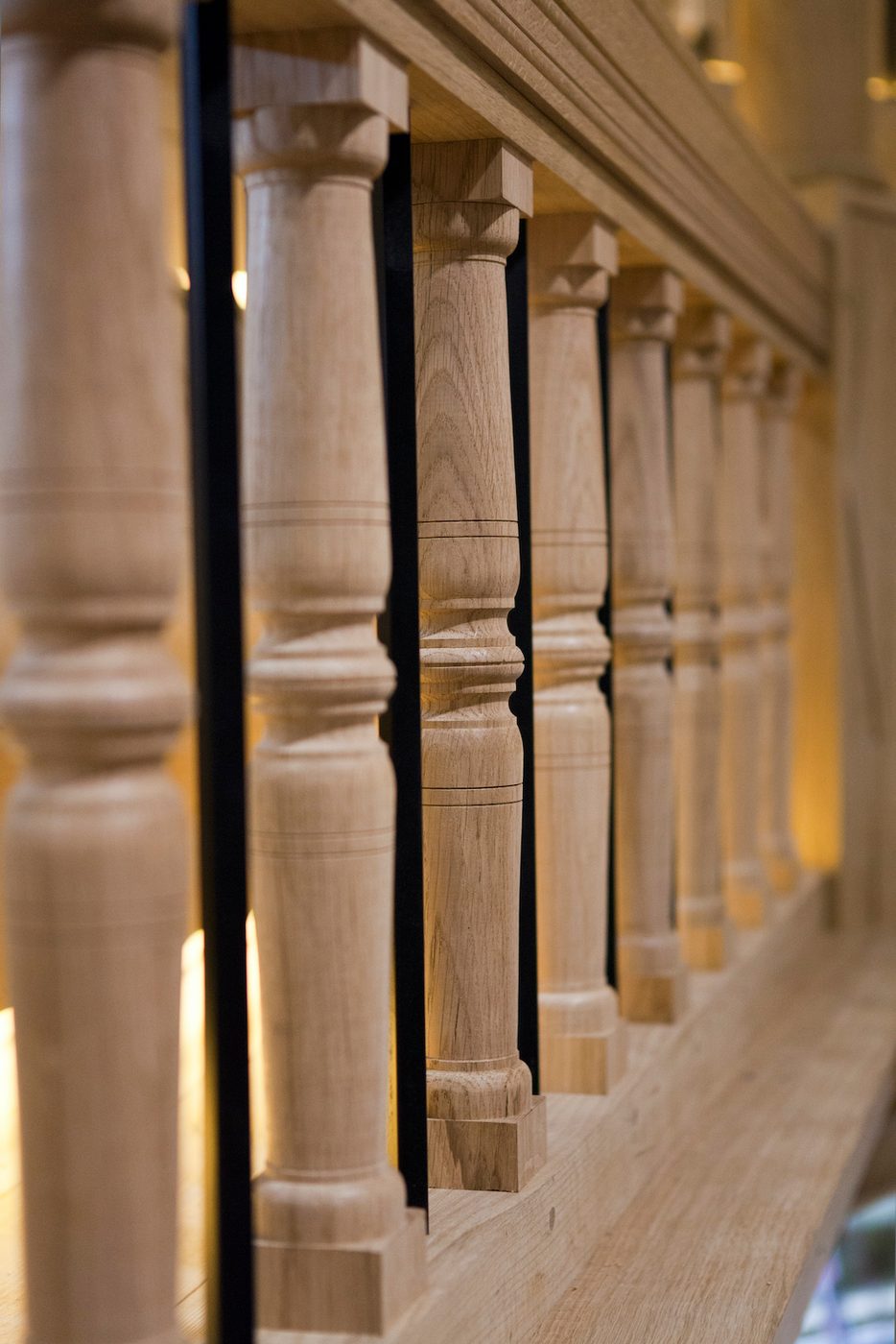 A close up of the wooden bars that line a gallery of a stage