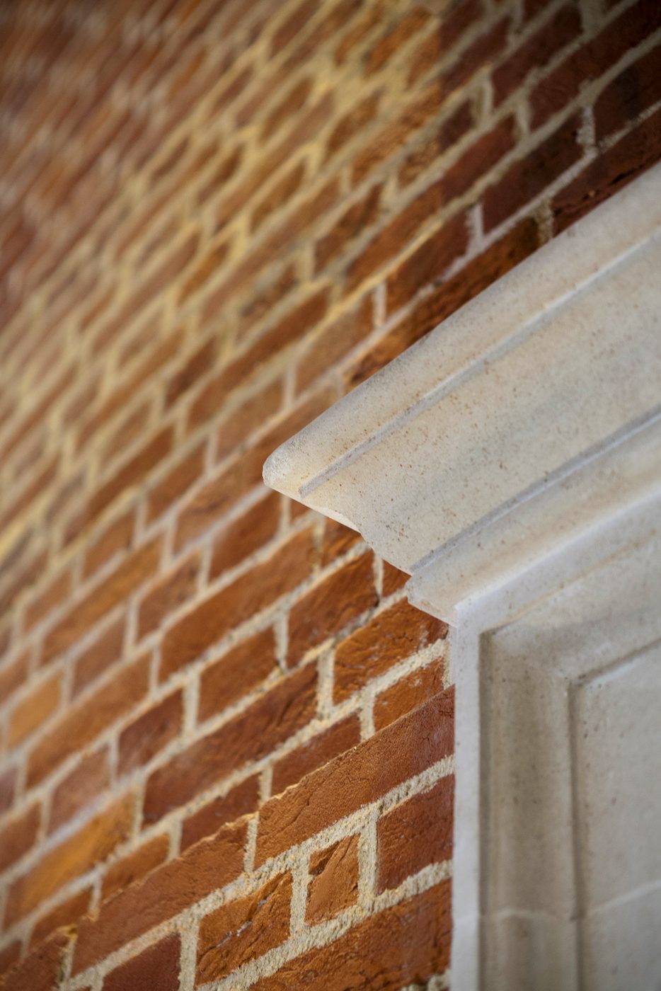 Details of a white door frame against a brick building