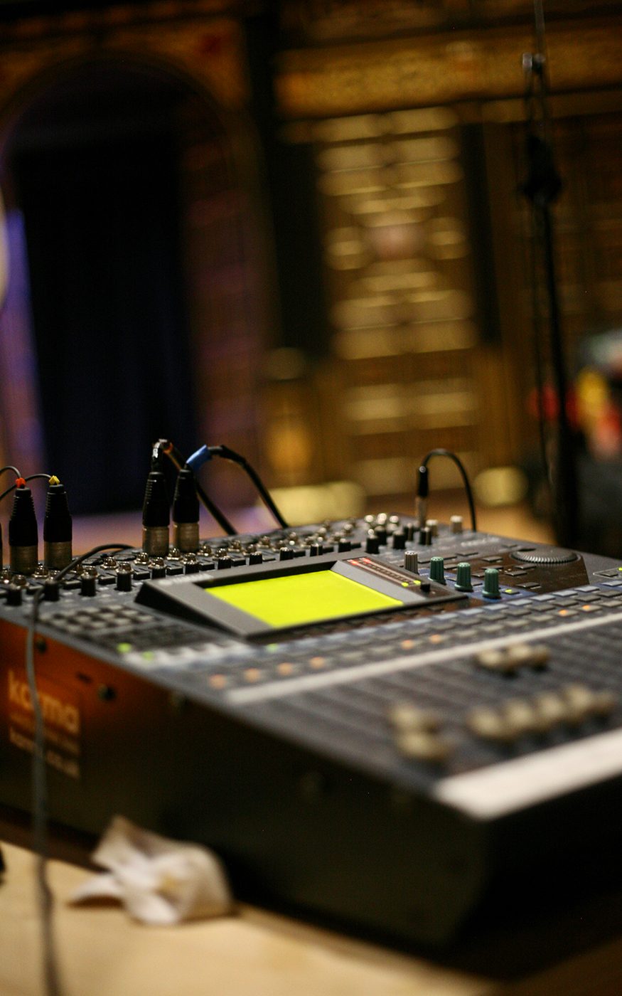 A close up of a black sound deck with wires coming out of it