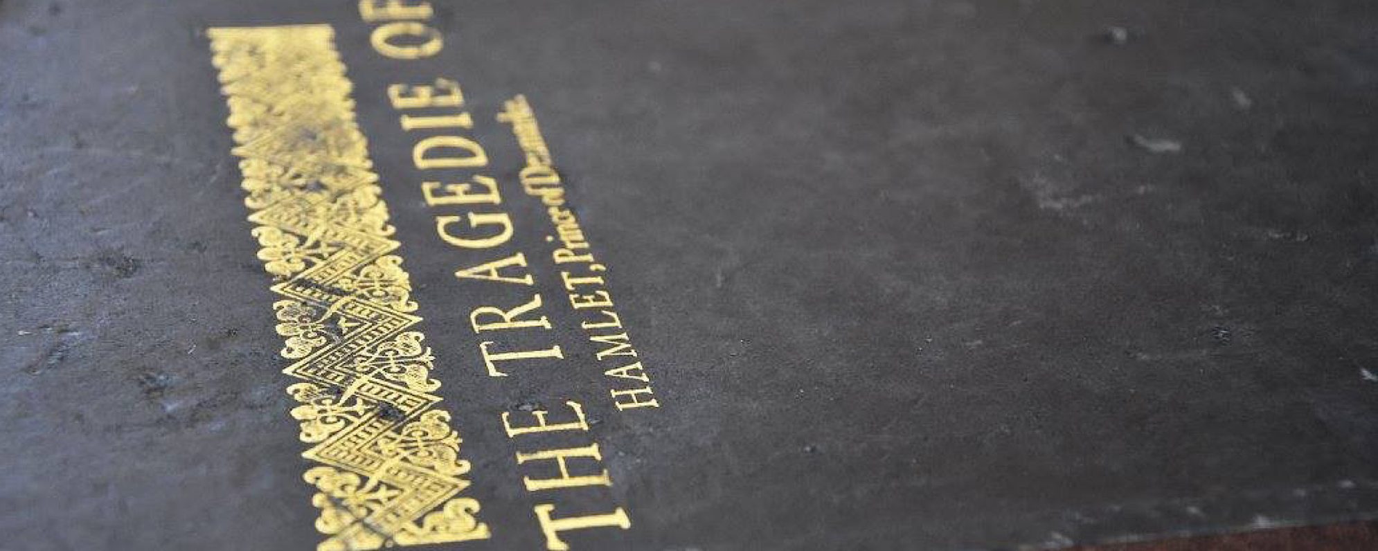 A black book with a gold title on it which reads The Tragedie of Hamlet of Denmark