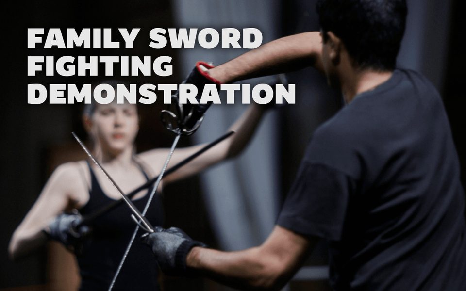 Two adults crossing swords with eachother. White overlaid text reads Family Sword Fighting Demonstration.