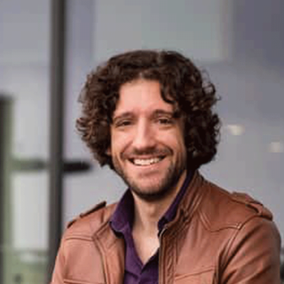 Headshot of Greg jenner looking straight to camera.