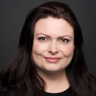 Headshot of Rosalind Blessed looking straight to camera.