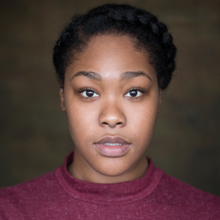 Headshot of Tanika Yearwood wearing a red tshirt looking straight to camera.