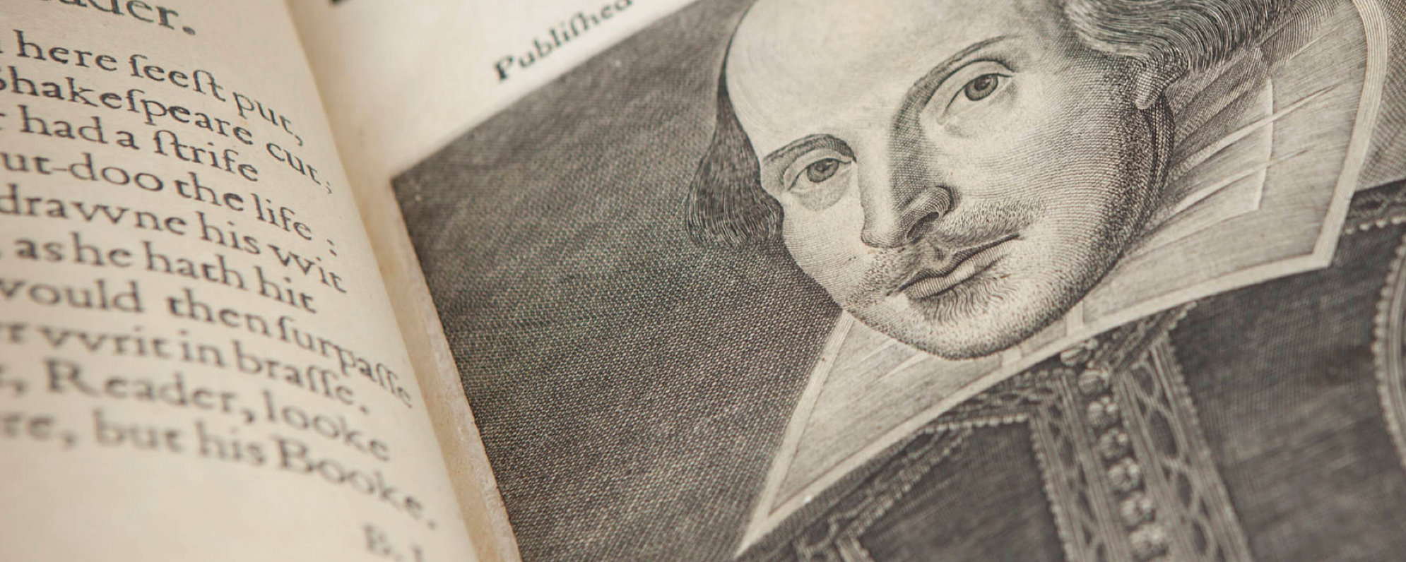 An open page of a book shows an illustration of the face of William Shakespeare